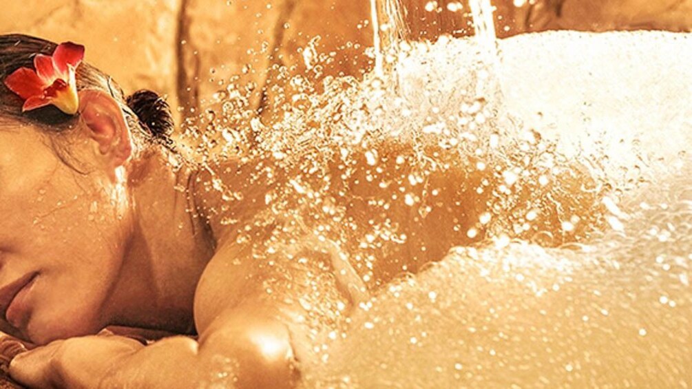 Close up of woman receiving hammam bath treatment.