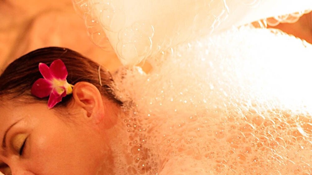 Close up of woman receiving hammam bath treatment.