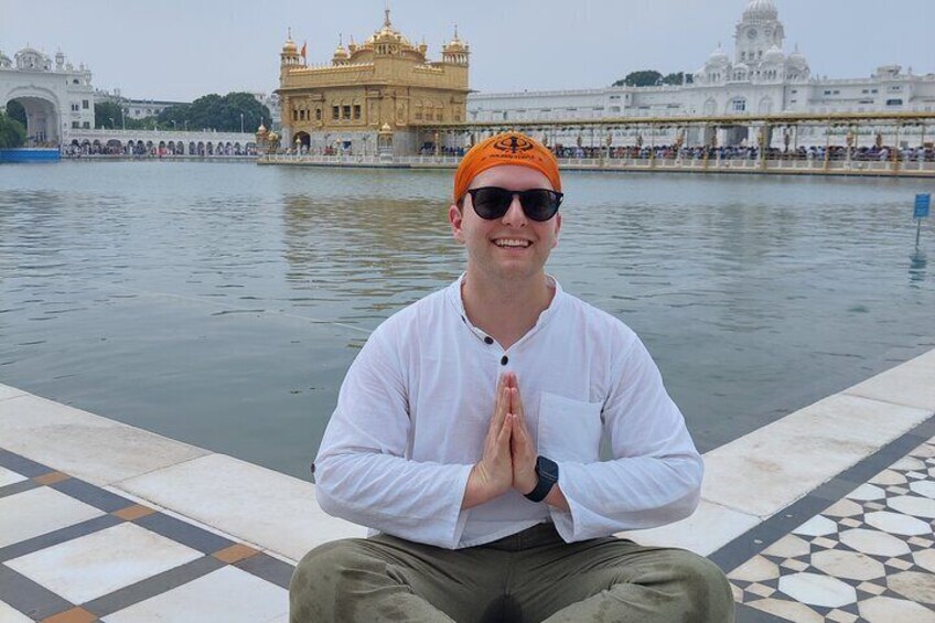 Guest reverential pose at golden temple