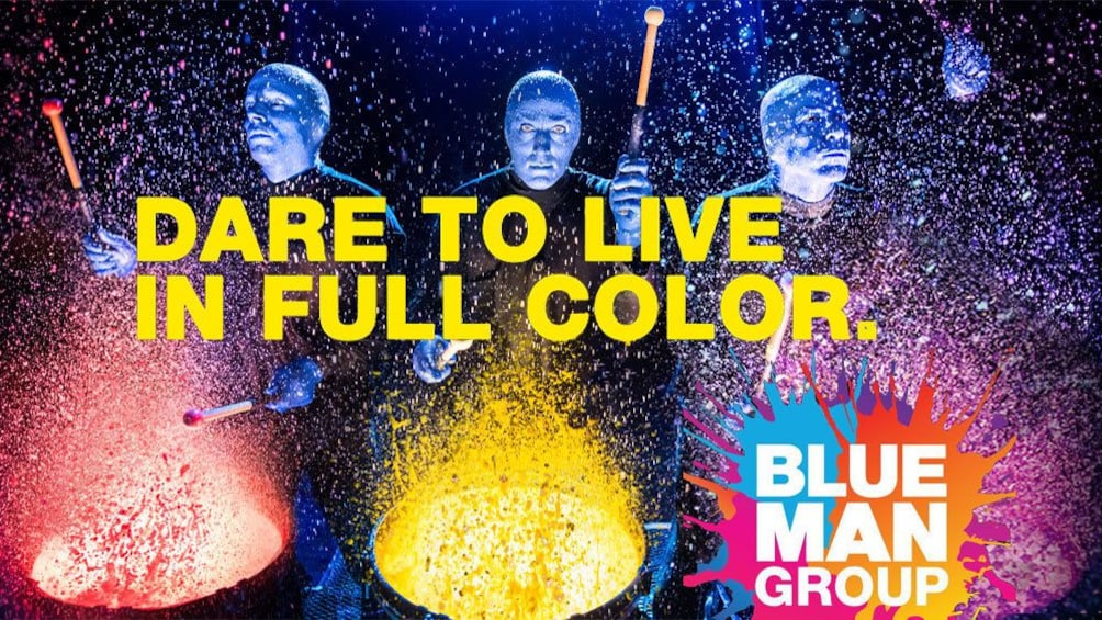 Blue Man Group banging on paint covered drums in New York