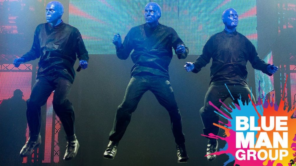 Blue Man Group jumping in the air onstage in New York