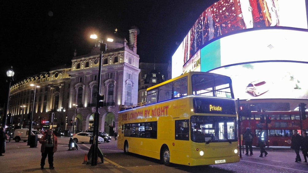 tour bus by big bright billboard in London