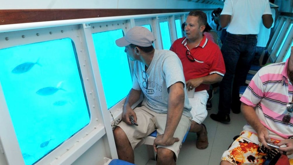 passengers gazing through the windows of a semisubmarine in San Andres