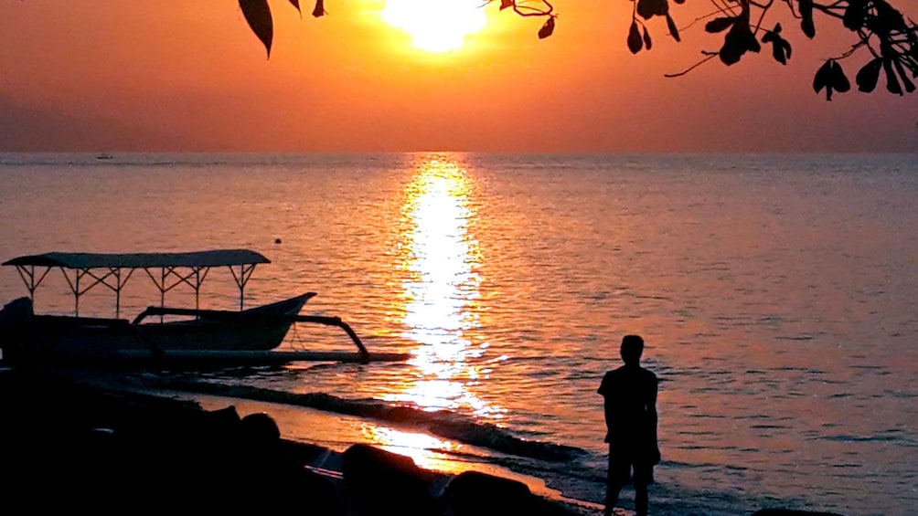 lone man watching the sunset at the beach in Bali