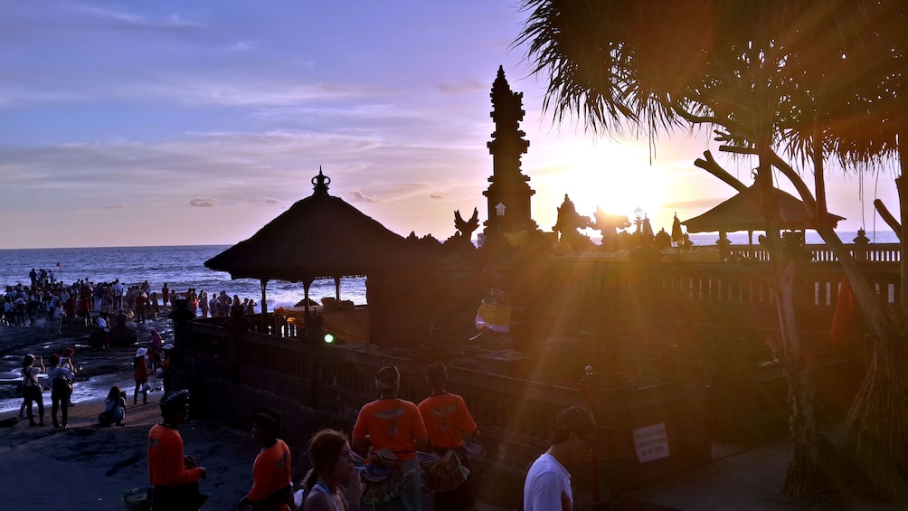 sun setting by the beach temple in Bali