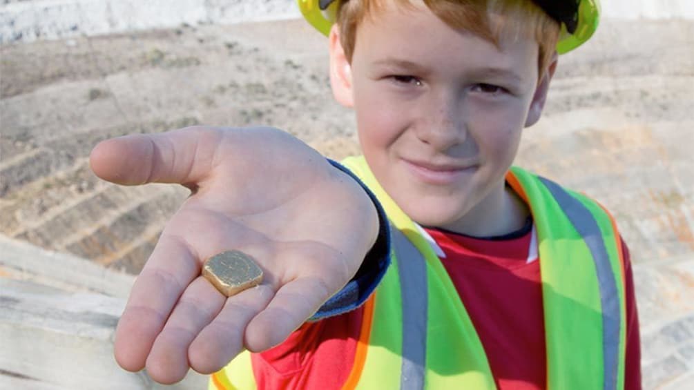 Child holding gold at the Waihi Gold Mine Tour in Waikato 