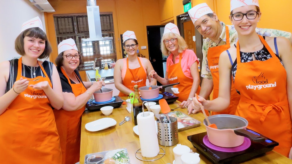 A large group enjoyin ga cultural cooking class in Singapore 