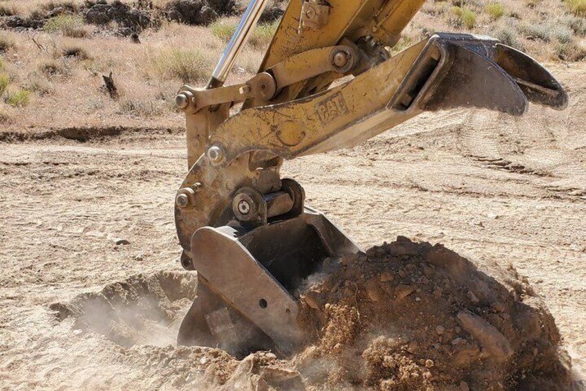 Dig In Las Vegas behind the controls of our Big Cat Excavator