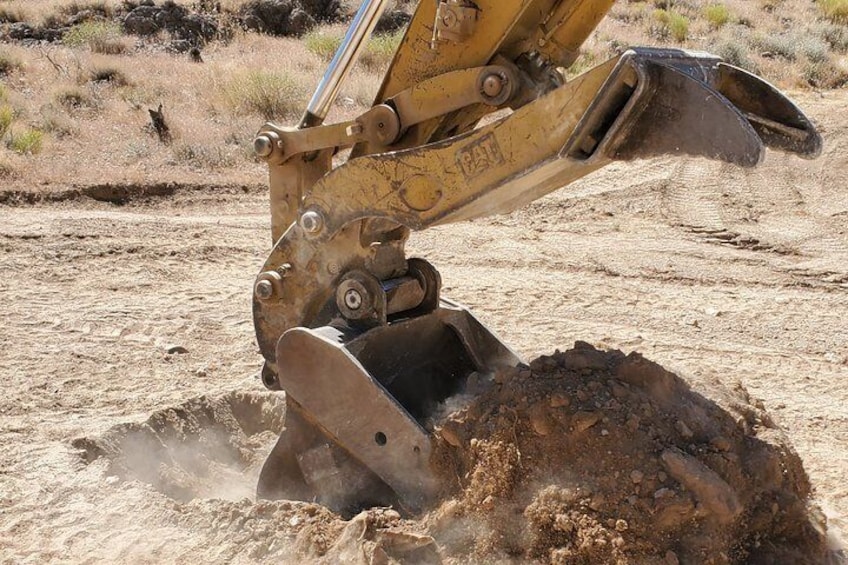 Dig In Las Vegas behind the controls of our Big Cat Excavator