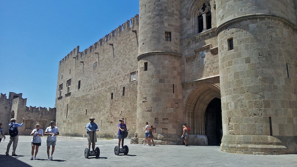 Show item 3 of 5. segway riders near landmark in Rhodes