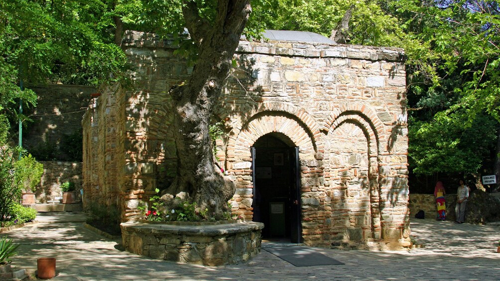 Show item 3 of 5. Outside the House of the Virgin Mary surrounded by trees