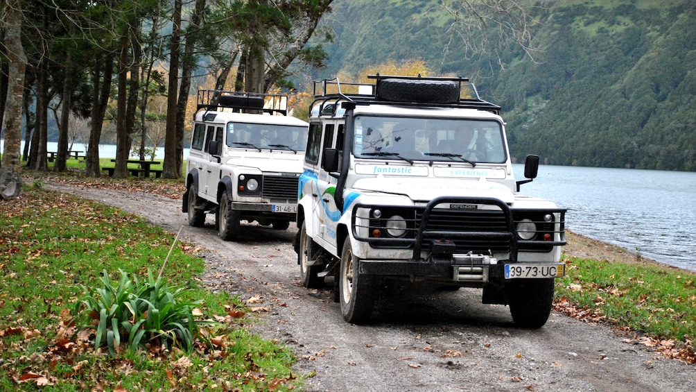 Two jeeps drive down dirt road in Sete Cidades Half-Day Safari