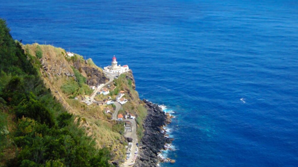 Aerial view of the ocean with part of island visible.