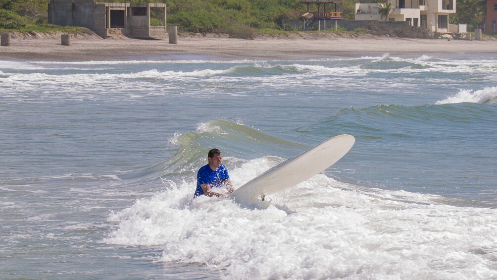 guy learning to surf in mexico