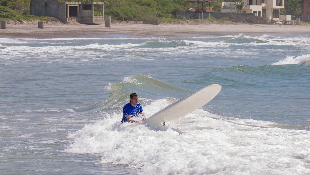 guy learning to surf in mexico