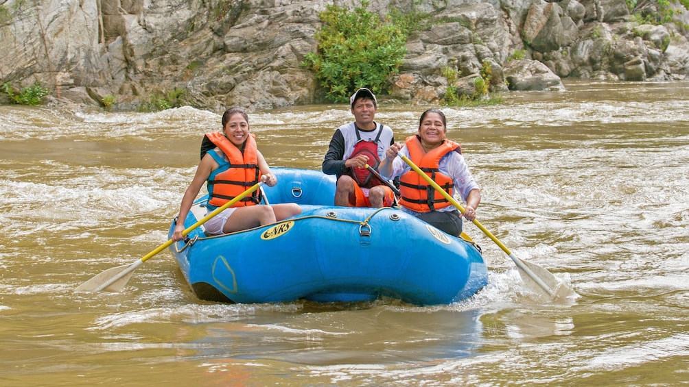 group of three rafters paddle down Rio Copalita
