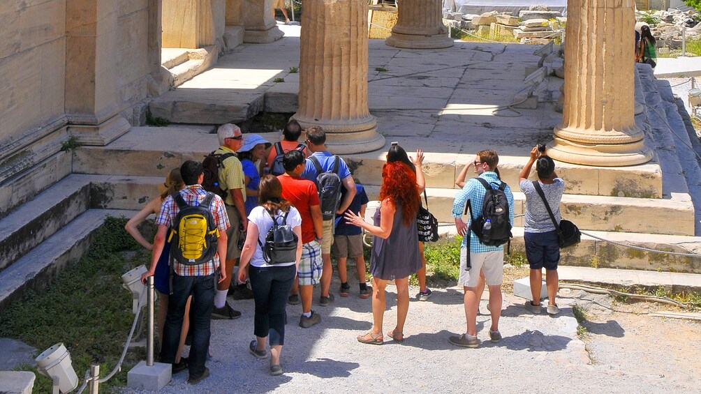 Tour group in Athens next to some columns