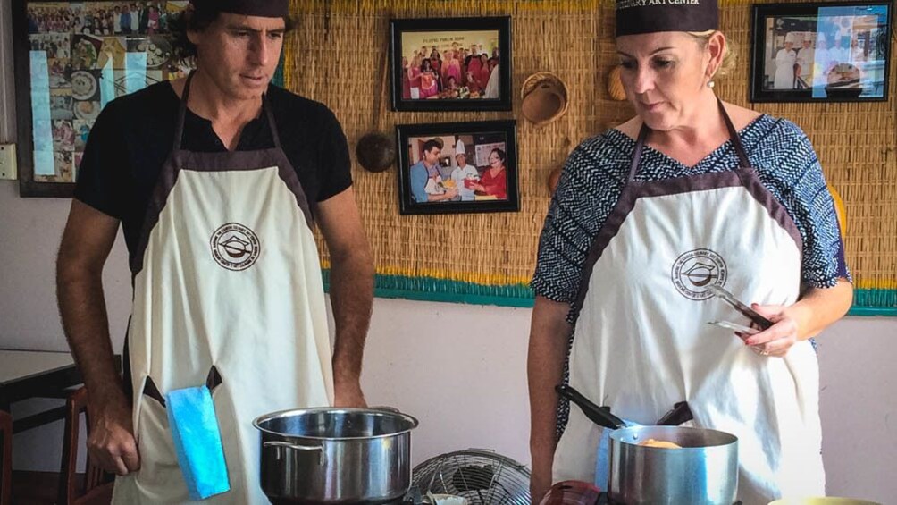 Male and female group members preparing to cook.