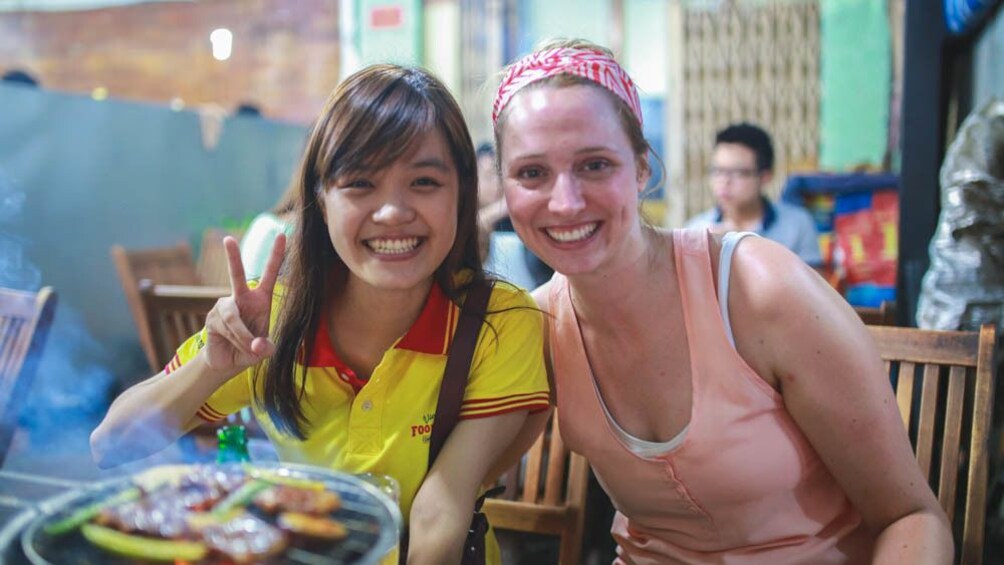 Close up of tourist and guide eating together.