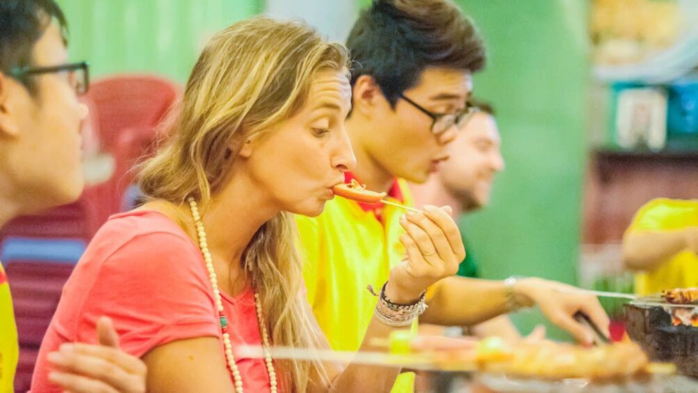 Close up of activity group eating good Vietnamese cuisine.