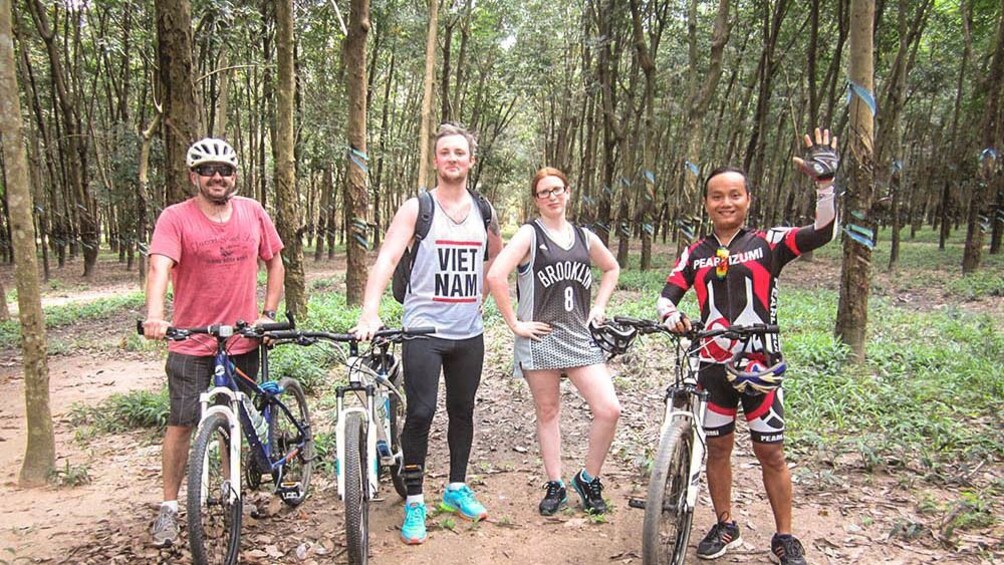 Cycling group posing together near Cu Chi tunnels.