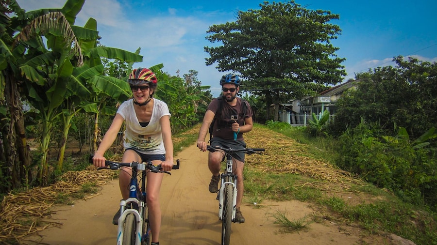 Couple riding on bike path in Mekong Delta.