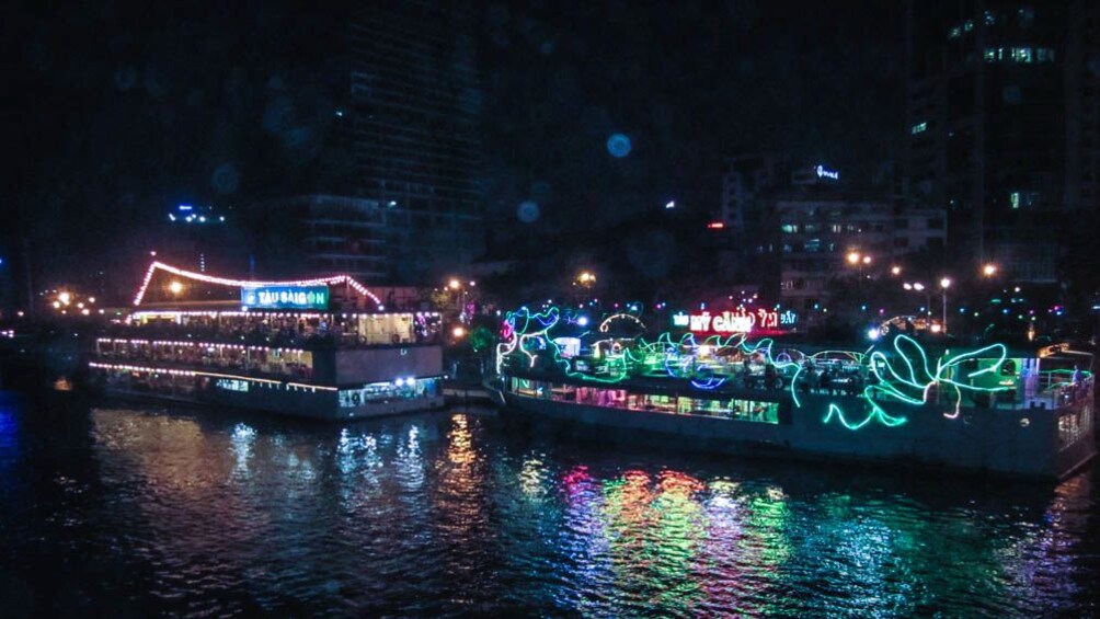 Illuminated ferry boat shown at night on the water.