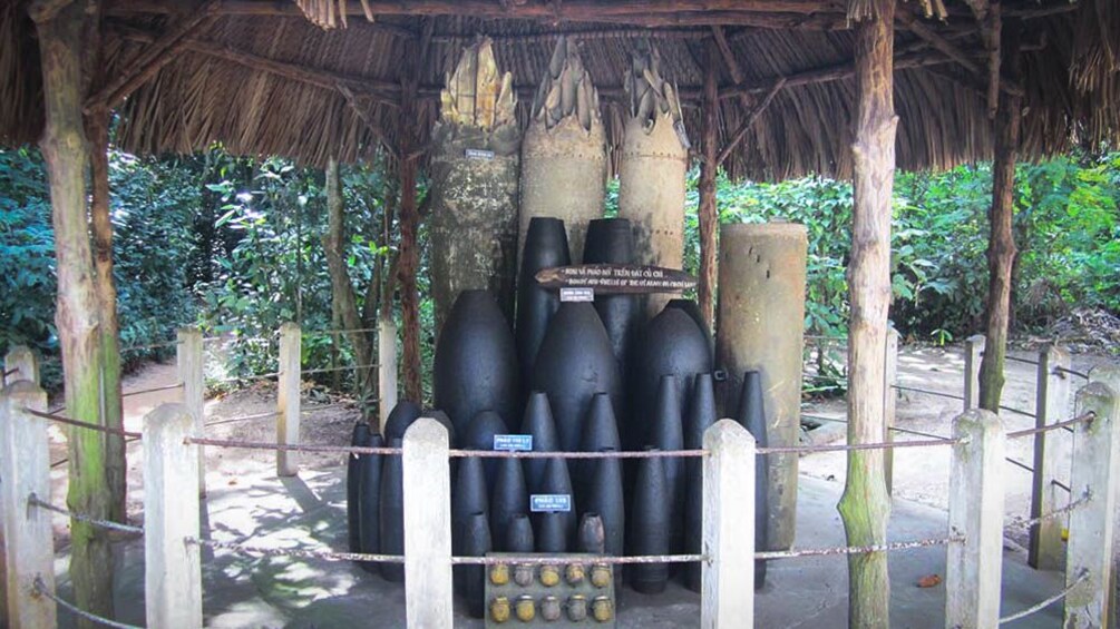 Old bombs shown under straw hut near Cu Chi Tunnels.