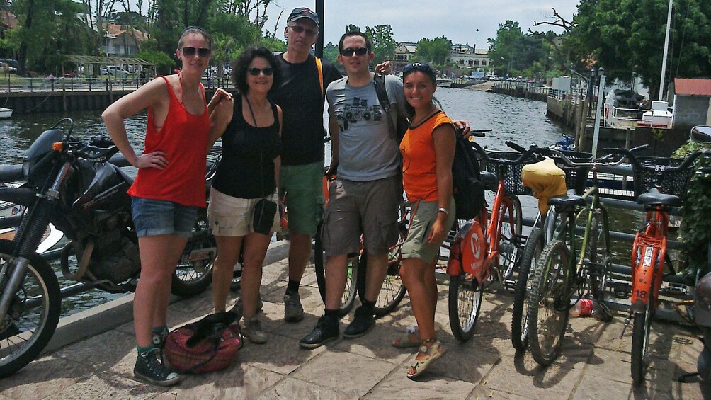 group posing with bicycles at river front