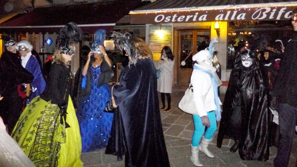 Street view of tour group on the carnival pub crawl tour in Venice 