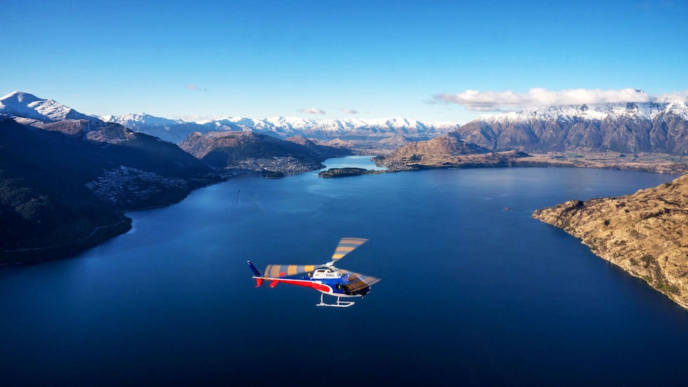 Helicopter flying over Lake Wakatipu in New Zealand