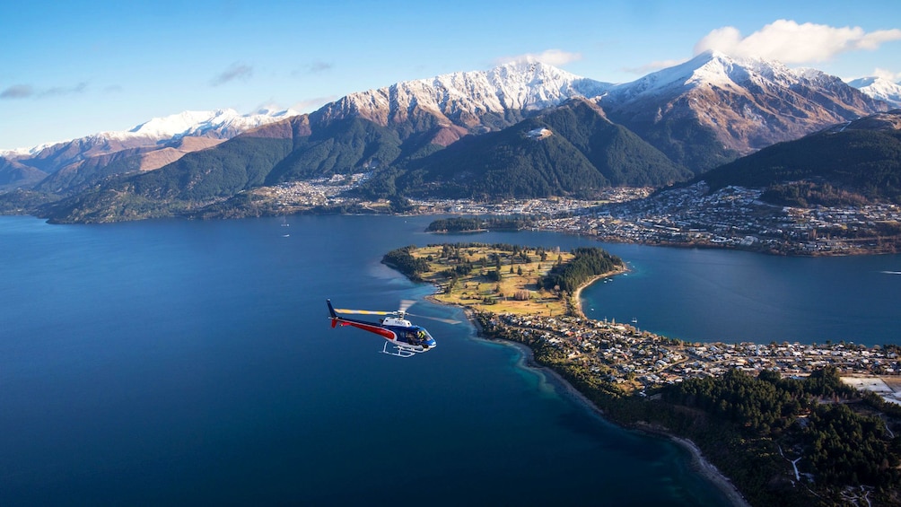 Helicopter flying over Queenstown and Lake Wakatipu in New Zealand