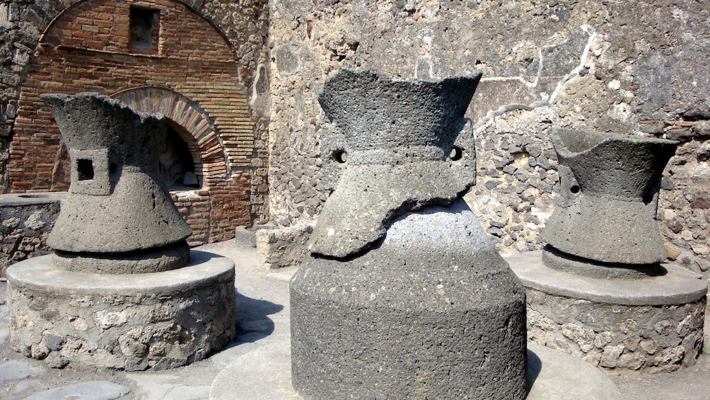 Three broken pillars in the ruins of Pompeii