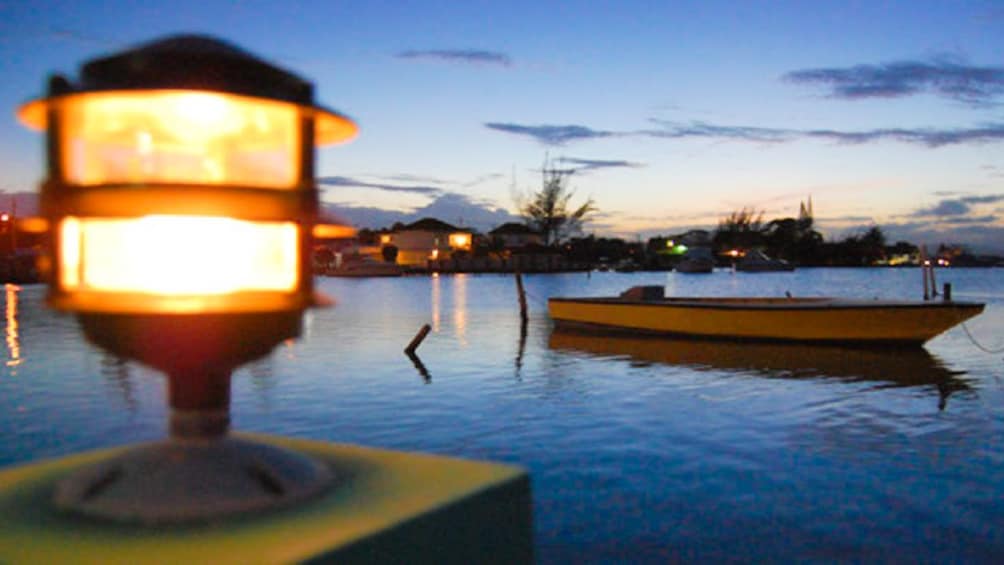 Evening view of lagoon with empty boat in the distance.