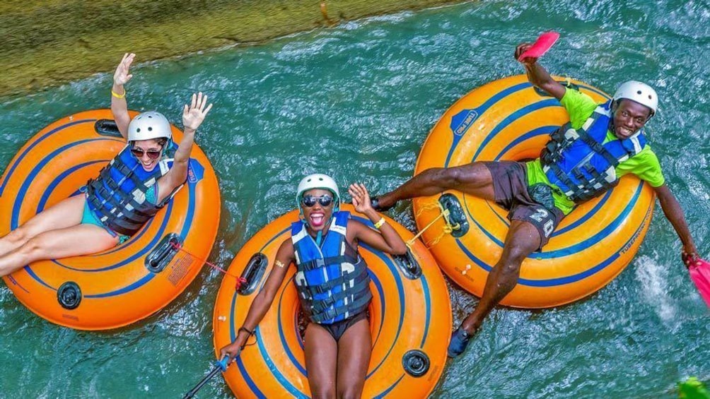 Three people on inner tubes  floating