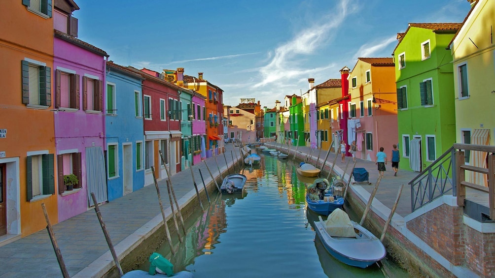 Multi-colored buildings split by a canal in Venice, Italy