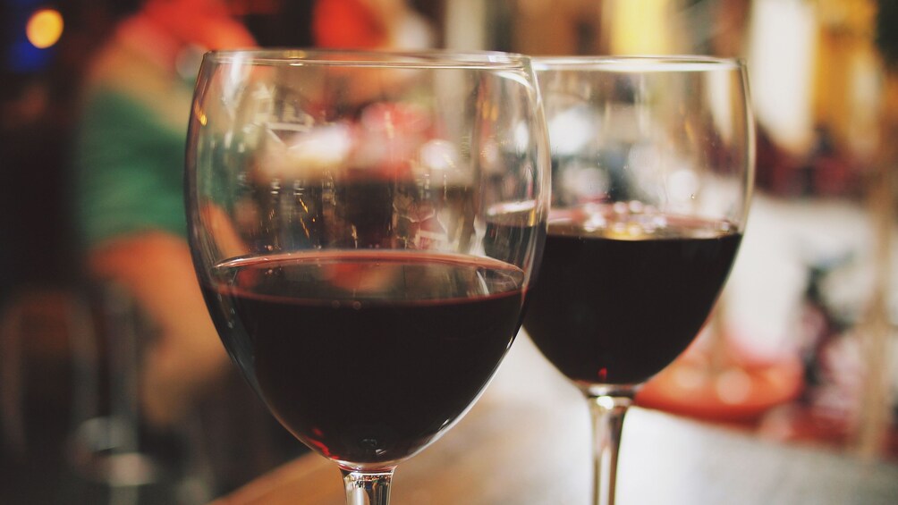 Two glasses of red wine with an out of focus background