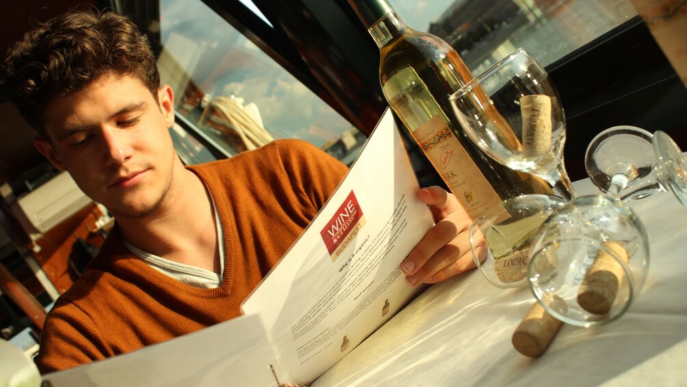 Man looks over Wine list on cruise