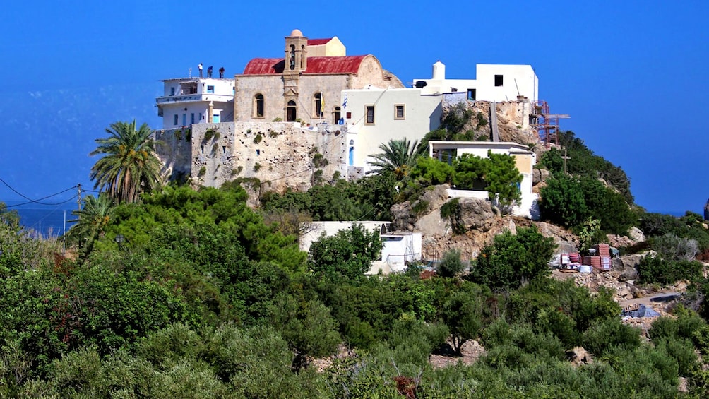 old building on top of a steep hill in Greece