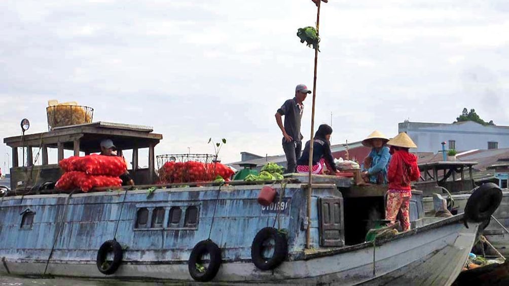 A large boat full of produce in the Cai Be floating market