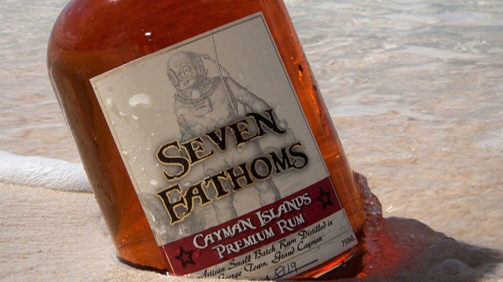 Bottle of rum on the beach in Cayman Islands