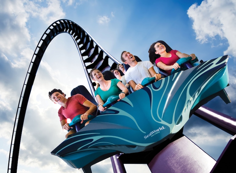 Show item 4 of 10. Group of People ride a roller coaster at Aquatica