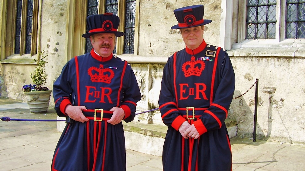 men in Beefeater apparel guarding the tower of london