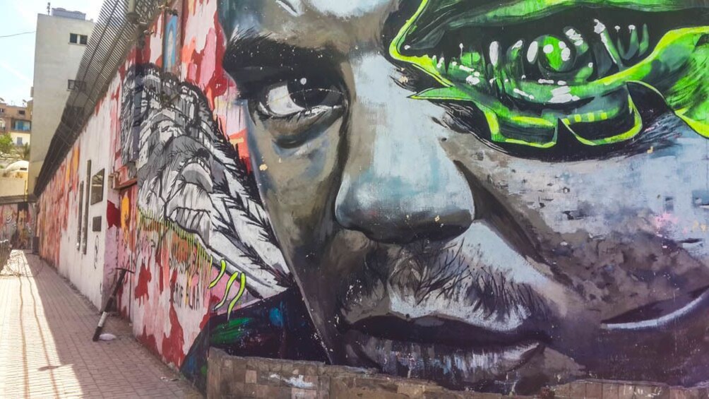 Detailed street art seen on side of building.