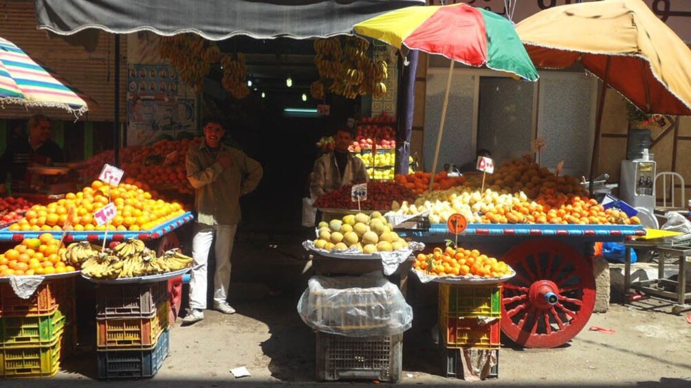 Local marketplace stand selling fresh fruit.