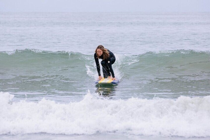 riding a wave on a surf lesson in morro bay