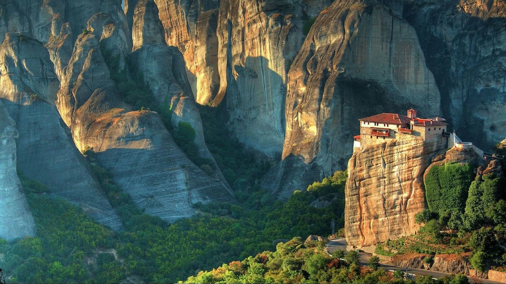 building on top of a tall cliff in Athens