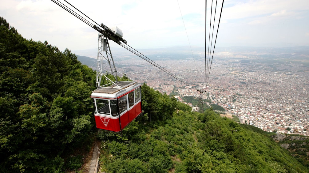 A gondola climbs up the side of a hill in Turkey