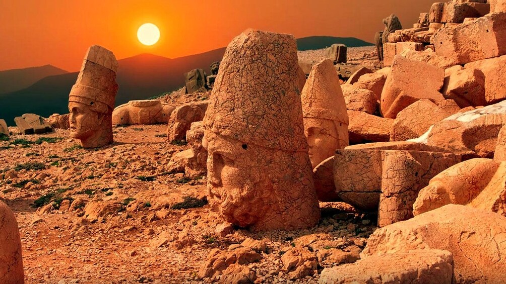 sun setting on Mount Nemrut sculptures in Istanbul
