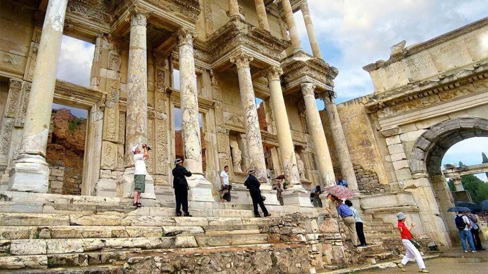 Tourists walking around the Library of Celsus in Istanbul